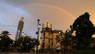 A man wearing protective face mask jogs under a rainbow as Malaysia reopens a majority of businesses, after a movement control order was imposed to fight the outbreak of the coronavirus disease (COVID-19), in Kuala Lumpur, Malaysia May 4, 2020. REUTERS/Li