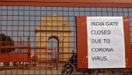 FILE PHOTO: A sign pasted on a security barricade is seen after the India Gate war memorial was closed for visitors amid measures for coronavirus prevention in New Delhi, India, March 19, 2020. REUTERS/Adnan Abidi/File Photo
