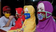 :A worker draws on protective masks amid the coronavirus disease (COVID-19) outbreak in Solo, Central Java Province, Indonesia May 6, 2020, in this photo taken by Antara Foto. Antara Foto/Maulana Surya/ via REUTERS ATTENTION EDITORS - THIS IMAGE WAS PROVI