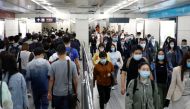 People wearing face masks walk inside a subway station during morning rush hour, following an outbreak of the coronavirus disease (COVID-19), in Beijing, China May 11, 2020. REUTERS/Carlos Garcia Rawlins