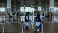 Airport staff cleans the arrivals terminal ahead of the arrival of an evacuation flight carrying Indian citizens from Gulf countries, at the Cochin International Airport in Kochi on May 6, 2020. AFP / Arunchandra Bose
