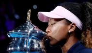 FILE PHOTO: Tennis - Australian Open - Women's Singles Final - Melbourne Park, Melbourne, Australia, January 26, 2019. Japan's Naomi Osaka kisses her trophy after winning her match against Czech Republic's Petra Kvitova. REUTERS/Kim Kyung-Hoon/File Photo