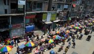 People make their way along a busy street in a market area during a government-imposed lockdown as a preventative measure against the spread of the COVID-19 coronavirus in Dhaka on May 12, 2020. / AFP / Munir Uz Zaman 