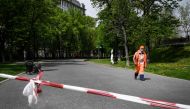 :A municipal worker walks along a boulevard in central Moscow on May 14, 2020, amid the outbreak of COVID-19, caused by the novel coronavirus. Moscow's streets remain depopulated despite half a million employed in construction and industry sectors were al