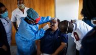 Doctors Without Borders (MSF) nurse Bhelekazi Mdlalose (3rd L), 51, illustrates how to perform a swab test on a nurse participating in a COVID-19 coronavirus training course for nurses at the City of Joburg Civic Centre in Roodeport, Johannesburg, on May 