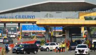 Indonesian police order some motorists who could not provide required travel documents to return at a check point in Bandung, West Java on May 20, 2020, during a partial lockdown amid concerns of the COVID-19 coronavirus pandemic as the government issued 