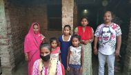 Jyoti Kumari Paswan (C-bottom) and her family stand in front of their house in Siruhully village at Darbhanga district, on May 23, 2020. AFP / STR
 