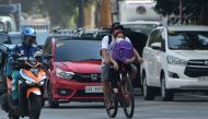 A couple ride on bicycle on a road in Manila on May 20, 2020. Bicycle sales have skyrocketed with some shops selling 300-400 units over the past two days since the Philippine government began easing quarantine measures to curb the spread of the COVID-19 c