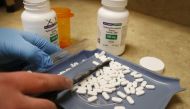 A pharmacy tech counts out pills of Hydroxychloroquine at Rock Canyon Pharmacy in Provo, Utah, on May 20, 2020. US President Donald Trump announced May 18 he has been taking hydroxychloroquine for almost two weeks as a preventative measure against COVID-1