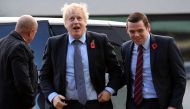 (FILES) In this file photo taken on November 07, 2019 Britain's Prime Minister Boris Johnson (C) is greeted by Conservative party candidate for Moray, Douglas Ross (R) as he arrives for a general election campaign visit to Diageo's Roseisle Distillery nea