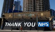 A cyclist rides past a thank you message in NHS in Shoreditch, following the outbreak of the coronavirus disease (COVID-19), London, Britain, May 30, 2020. REUTERS/John Sibley