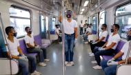 Police trainees wearing personal protective equipment maintain social distancing in a train during a simulation exercise in preparation for the resumption of train operations, amid the coronavirus disease (COVID-19) outbreak, in Manila, Philippines May 26