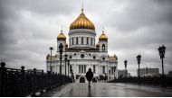 A woman walks in front of Christ-the-Savior cathedral in central, the main Russian Orthodox church in central Moscow, on June 2, 2020, amid the outbreak of COVID-19, caused by the novel coronavirus, as Moscow authorities started opening churches, mosques 