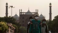 People walk along a street outside the Jama Masjid after the government eased a nationwide lockdown imposed as a preventive measure against the COVID-19 coronavirus in the old quarters of New Delhi on June 5, 2020. AFP / XAVIER GALIANA