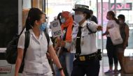 :A guard guides shoppers through a walkway, as part of social distancing measures to prevent the spread of the COVID-19 novel coronavirus, at a mall in Manila on June 2, 2020, a day after the government eased up quarantine measures in the country's capita