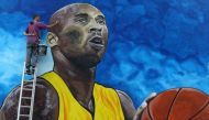 Artist Deni Bozic (27) paints the last details on his tribute mural honoring former Los Angeles Lakers basketball star Kobe Bryant on a school building wall in Gradiska, Bosnia and Herzegovina June 8, 2020. Picture taken June 8, 2020. REUTERS/Dado Ruvic
