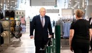 Prime Minister Boris Johnson speaks with a staff member as he visits the M&S clothing department and other retail outlets in Westfield Stratford to see the COVID-19 measure taken before reopening tomorrow, in London, Britain June 14, 2020. John Nguyen/Poo