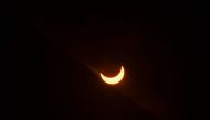 The moon partially covers the sun during an annular solar eclipse as seen from New Delhi on June 21, 2020. / AFP / Jewel Samad