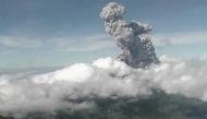 This handout photo taken and released on June 21, 2020 by Indonesia's Research and Technology Development for Geological Hazard Mitigation (BPPTKG) shows the Merapi Mount volcano spewing thick smoke into the air as seen from Yogyakarta. AFP PHOTO / BPPTKG