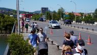 People walk on the Santiago bridge over the Bidasoa river separating Spain and France as Spain reopens its borders to most European visitors after the coronavirus lockdown coinciding with the end of the state of emergency in the country, in Irun, Spain Ju
