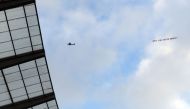 A plane towing a banner reading 'White Lives Matter Burnley' is seen in the sky above the stadium during the English Premier League football match between Manchester City and Burnley at the Etihad Stadium in Manchester, north west England, on June 22, 202
