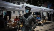 A statue wearing a face mask is pictured in downtown Lisbon on June 23, 2020. Portugal's Prime Minister Antonio Costa said on June 22, 2020 that some coronavirus restrictions would be reimposed in the capital Lisbon to help control outbreaks from the pand