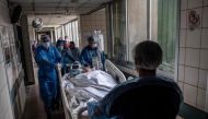 Nurses transfer a COVID-19 patient to the Critical Patients Unit, at Barros Luco Hospital, in Santiago, on June 24, 2020.AFP / Martin BERNETTI