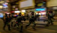 TOPSHOT - Police charge towards protesters during a rally against a new national security law in Hong Kong on July 1, 2020, on the 23rd anniversary of the city's handover from Britain to China./ AFP / Anthony WALLACE
 
