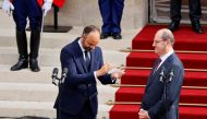 Former French Prime Minister Edouard Philippe applauds newly-appointed Prime Minister Jean Castex in the courtyard of the Matignon Hotel during the handover ceremony in Paris, France July 3, 2020. Thomas Samson/Pool via REUTERS