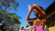 People pray during a ceremony dedicated to the Hindu deity Saraswati at Jagatnatha temple in Denpasar on the Indonesian resort island of Bali on July 4, 2020. / AFP / SONNY TUMBELAKA