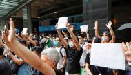  Supporters raise white paper to avoid slogans banned under the national security law as they support arrested anti-law protester outside Eastern court in Hong Kong, China July 3, 2020. REUTERS/Tyrone Siu/File Photo
