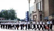 Personnel of Beijing railway station wearing face masks arrive for work in Beijing on July 5, 2020. / AFP / NOEL CELIS