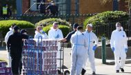 Response personnel prepare to distribute goods to residents inside a public housing tower, locked down in response to an outbreak of the coronavirus disease (COVID-19), in Melbourne, Australia, July 9, 2020. AAP Image/James Ross via Reuters