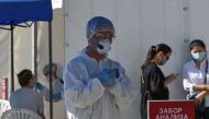 Medical specialists wearing protective equipment work at the coronavirus disease (COVID-19) testing facility in Almaty, Kazakhstan July 8, 2020. REUTERS/Mariya Gordeyeva
