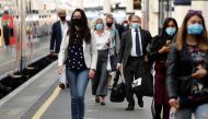 Workers wearing face-masks arrive at Waterloo Station during the morning rush hour following the coronavirus disease (COVID-19) outbreak, in London, Britain, July 6, 2020. REUTERS/Toby Melville