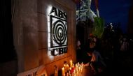 A journalist lights a candle outside the ABS-CBN headquarters, following Philippine congress' vote against the broadcast network's franchise renewal, in Quezon City, Metro Manila, Philippines, July 10, 2020. REUTERS/Eloisa Lopez