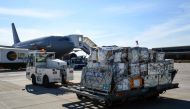 A soldat of the German Air Force puts medical equipment into an Airbus A310 of the German armed forces Bundeswehr before a flight to Armenia at the military part of the airport in Cologne, western Germany, on July 13, 2020.  AFP / Ina FASSBENDER