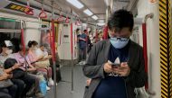 Passengers wear surgical masks in an MTR train, following the outbreak of the coronavirus (COVID-19) in Hong Kong, China July 13, 2020. REUTERS/Tyrone Siu