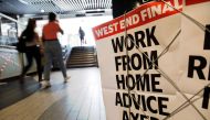An advertising board for the Evening Standard newspaper carries the hadline 'work from home advice axed' in London on July 17, 2020. AFP / Tolga AKMEN