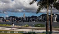 A girl (L) rides her scooter at the west kowloon cultural district in Hong Kong on July 18, 2020. / AFP / ISAAC LAWRENCE