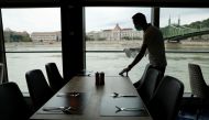 A crew member prepares a table on the NickoVision river cruise boat following the coronavirus disease (COVID-19) outbreak in Budapest, Hungary, July 16, 2020. Picture taken July 16, 2020. REUTERS/Bernadett Szabo