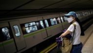 FILE PHOTO: A commuter wearing a protective face mask waits for a train at the metro station on Syntagma square, on the first day of easing of a nationwide lockdown against the spread of coronavirus disease (COVID-19), in Athens, Greece, May 4, 2020. REUT