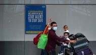 Travellers wearing face masks walk at the Terminal 5 at Heathrow Airport, as the spread of the?coronavirus?disease (COVID-19) continues, in London, Britain, July 26, 2020. REUTERS/Henry Nicholls