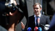 French Health Minister Olivier Veran speaks to the press after visitng French postal service 