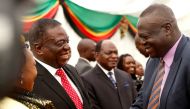 FILE PHOTO: Zimbabwean President Emmerson Mnangagwa congratulates Perrance Shiri, the new minister of Land, Agriculture and Land Resettlement are seen after the swearing in of cabinet ministers at State House in Harare, Zimbabwe December 4, 2017. REUTERS/