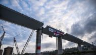 (FILES) This file photo taken on April 27, 2020 shows a view of the last 44 meter long span (Top C) that is being hoisted between columns 10 and 11 on the bridge's eastern side in Genoa, during the country's lockdown aimed at curbing the spread of the COV
