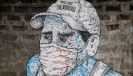 A mural of a man wearing a mask is pictured on a sidewalk amid the coronavirus disease (COVID-19) outbreak in Quezon City, Metro Manila, Philippines, July 30, 2020. REUTERS/Eloisa Lopez 