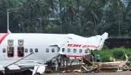 Officials inspect the site where a passenger plane crashed when it overshot the runway at the Calicut International Airport in Karipur, in the southern state of Kerala, India, August 8, 2020. REUTERS/Stringer