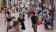 People wearing face masks walk down a shopping street in the Las Delicias neighbourhood of Zaragoza in northeastern Spain on August 10, 2020. Spain has added 19,405 new coronavirus cases in the past week, but the health ministry says the country is not en