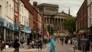 Members of the public walk through the centre of Preston, north west England on August 8, 2020, as local lockdown restrictions are reimposed due to a spike in cases of the novel coronavirus in the city. / AFP / OLI SCARFF